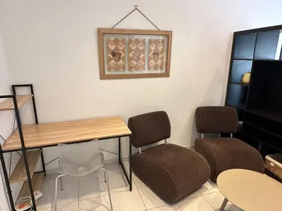 a room with a table and chairs and a piano at STUDIO REFAIT A NEUF CENTRE DE NICE in Nice