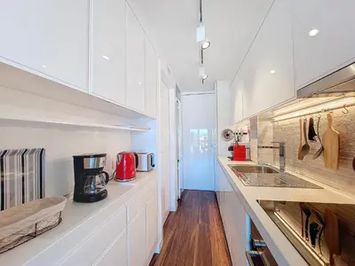 a kitchen with white cabinets and a counter top at Nestor&Jeeves - BREAKTIME - Sea View - Parking in Nice