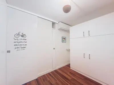 an empty room with white cabinets and wood floors at Nestor&Jeeves - BREAKTIME - Sea View - Parking in Nice