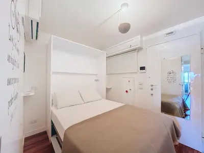 a small white bedroom with a bed in it at Nestor&Jeeves - BREAKTIME - Sea View - Parking in Nice