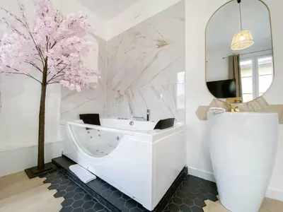 a bathroom with a white sink and a tree at Hotel Les Orangers in Nice