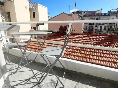 a table and two chairs on a balcony at Studio Moderne Rénové avec balcon in Nice