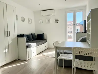 a living room with a couch and a table at Studio Moderne Rénové avec balcon in Nice