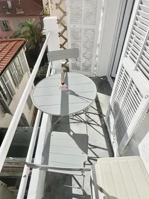 a table and two chairs on a balcony at Studio Moderne Rénové avec balcon in Nice