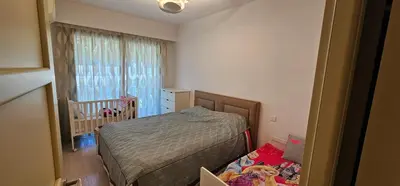 a small bedroom with a bed and a crib at bella d'azur in Nice