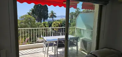 a room with a table and chairs on a balcony at bella d'azur in Nice