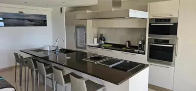 a kitchen with a large island with a counter top at bella d'azur in Nice