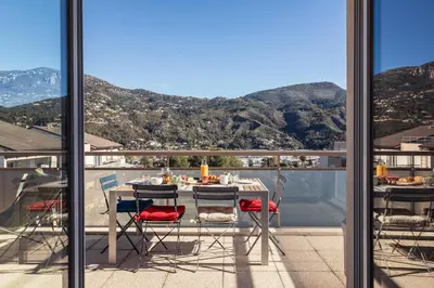 a table and chairs on a balcony with a view at Appartement in Carros