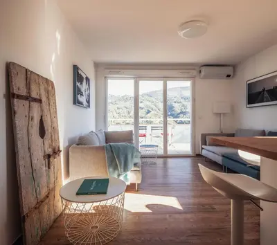 a living room with a couch and a table at Appartement in Carros