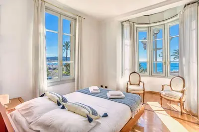 a bedroom with a bed with a view of the ocean at #15 Sea front Villa AC stunning view for 6 pers wifi in Nice