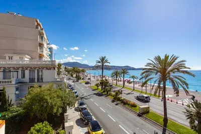 a city street with palm trees and a building at #15 Sea front Villa AC stunning view for 6 pers wifi in Nice