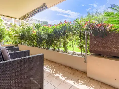 a balcony with chairs and a garden with flowers at Apartment Les Balcons d'Eze-3 by Interhome in Èze