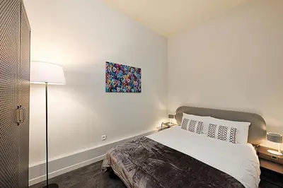a bedroom with a bed and a painting on the wall at #18 Rossetti Suite 2 Bedrooms , Central Old Nice/AC in Nice