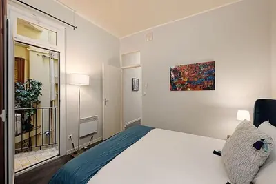 a bedroom with a bed and a painting on the wall at #18 Rossetti Suite 2 Bedrooms , Central Old Nice/AC in Nice