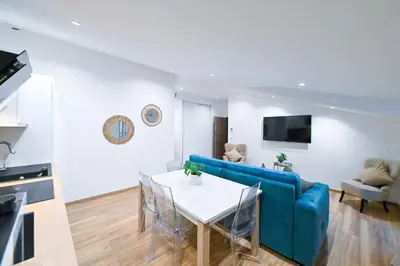 a living room with a blue couch and a table at Trois pièces cozy n14 in Nice