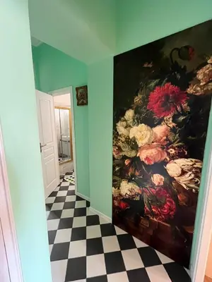 a painting of flowers on a wall in a hallway at Appartement Nice Port Lympia Wifi Top Location in Nice
