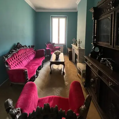 a living room with red couches and a table at Appartement Nice Port Lympia Wifi Top Location in Nice