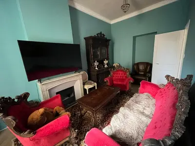 a living room with pink furniture and a flat screen tv at Appartement Nice Port Lympia Wifi Top Location in Nice