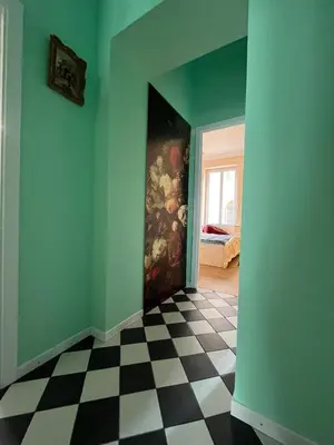 a room with a painting on the wall and a checkered floor at Appartement Nice Port Lympia Wifi Top Location in Nice