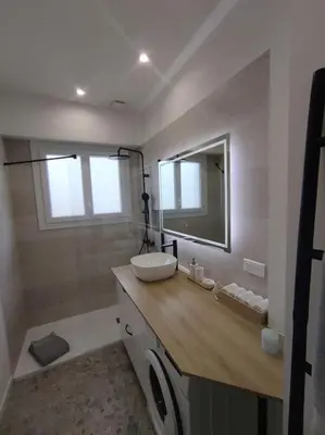 a bathroom with a sink and a mirror at Bel appartement - plage à 50 m in Nice