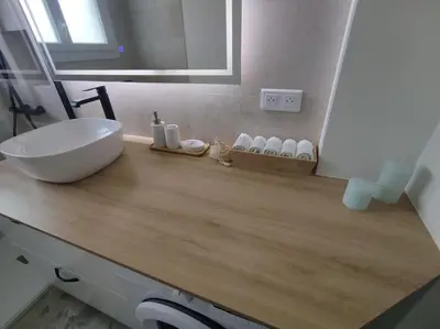 a bathroom with a white sink on a wooden counter at Bel appartement - plage à 50 m in Nice