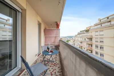 a balcony with a table and chairs and a view at Le Mistral in Nice