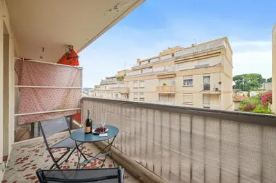 a balcony with a table and chairs and a building at Le Mistral in Nice