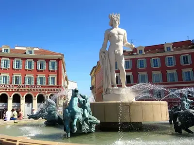 a statue in a fountain in front of a building at Luxury apartment on Promenade des Anglais in Nice in Nice
