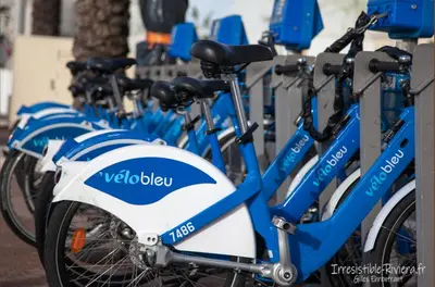 a row of blue and white bikes parked next to each other at Luxury apartment on Promenade des Anglais in Nice in Nice