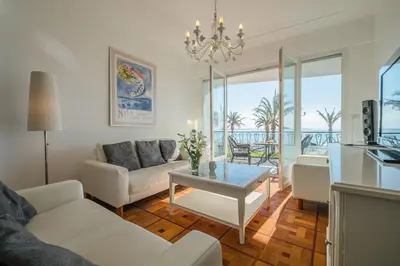 a living room with a couch and a table at Luxury apartment on Promenade des Anglais in Nice in Nice