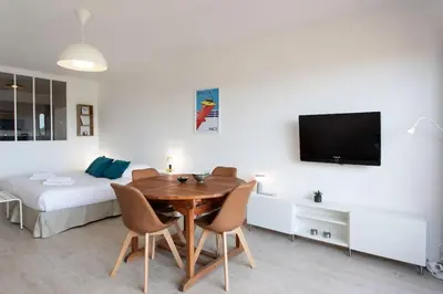 a room with a table and chairs and a bed at L20 Stunning sea view, terrace, parking, AC, Wifi in Nice