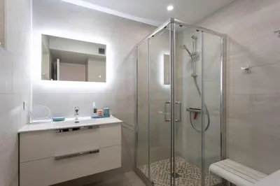 a bathroom with a glass shower and a sink at L20 Stunning sea view, terrace, parking, AC, Wifi in Nice