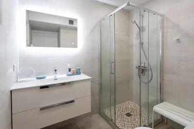 a bathroom with a glass shower and a sink at L20 Stunning sea view, terrace, parking, AC, Wifi in Nice