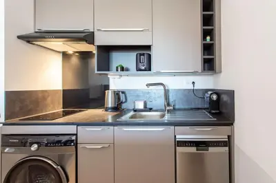 a kitchen with a sink and a washing machine at L20 Stunning sea view, terrace, parking, AC, Wifi in Nice