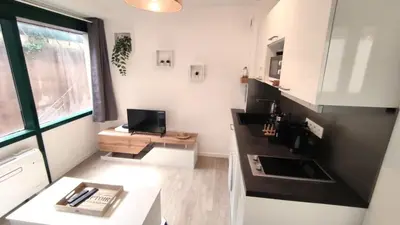 a small kitchen with a desk and a window at Dana centre mer 25 in Nice