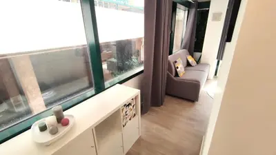 a living room with a couch and a large window at Dana centre mer 25 in Nice