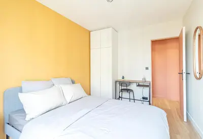 a bedroom with a white bed and a desk at Charmant appartement à Nice in Nice