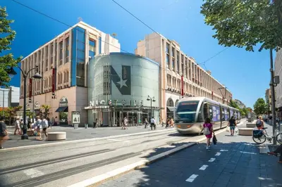 a bus driving down a street in a city at ⁂ Studio cosy 3 min de la plage terrasse clim in Nice