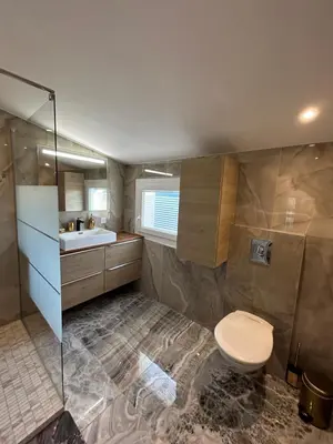 a bathroom with a toilet and a sink at Duplex Oliveraie piscine au sel marin et parking in Nice