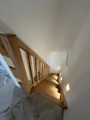 a staircase in a house with a wooden stair case at Duplex Oliveraie piscine au sel marin et parking in Nice