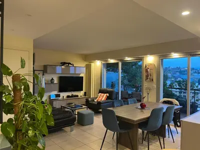 a living room with a table and a couch at Duplex Apartment, Sea View and Swimming Pool in Nice