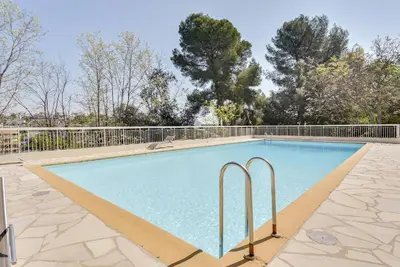 a swimming pool with two metal bars around it at Duplex Apartment, Sea View and Swimming Pool in Nice
