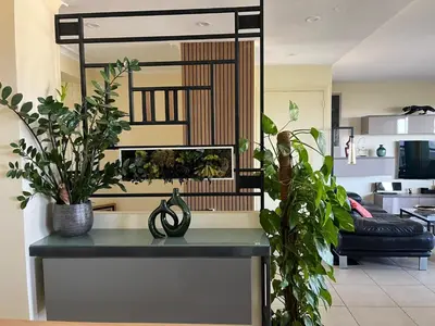 a table with plants on it in a living room at Duplex Apartment, Sea View and Swimming Pool in Nice