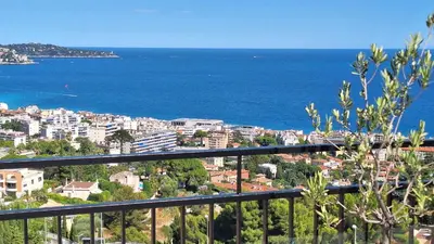 a view of a city and the ocean from a balcony at Chambre d'hôtes pleine vue mer in Nice
