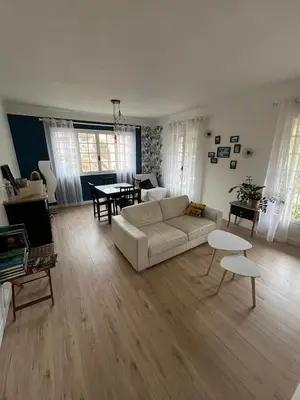 a living room with a couch and a table at chez steph in La Trinité