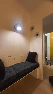 a room with a couch and a light on the wall at chez steph in La Trinité
