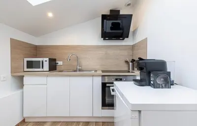 a kitchen with a microwave oven and a sink at Studio cozy avec terrasse n12 in Nice