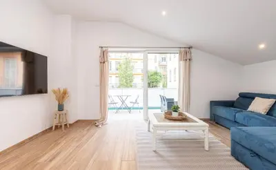 a living room with a blue couch and a table at Studio cozy avec terrasse n12 in Nice
