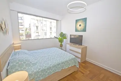 a bedroom with a bed and a window at Luxury Sea Front Condo Milord in Nice