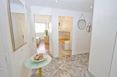 a hallway with a table and a room with a bedroom at Luxury Sea Front Condo Milord in Nice